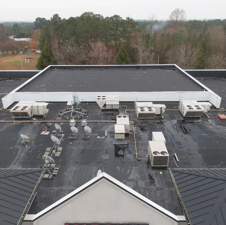 Aerial view of a large low-slope commercial roof with rooftop equipment