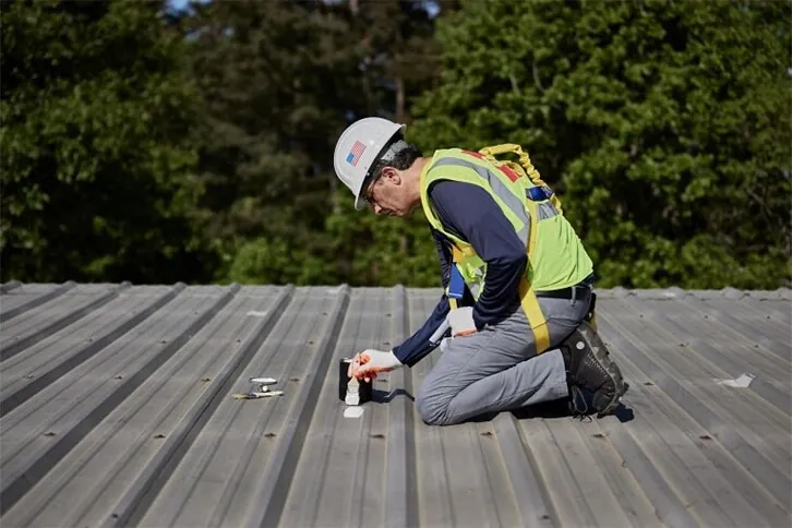Exposed fasteners being encapsulated on a metal roof
