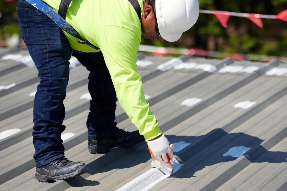 Seams on a metal roof being treated before coating